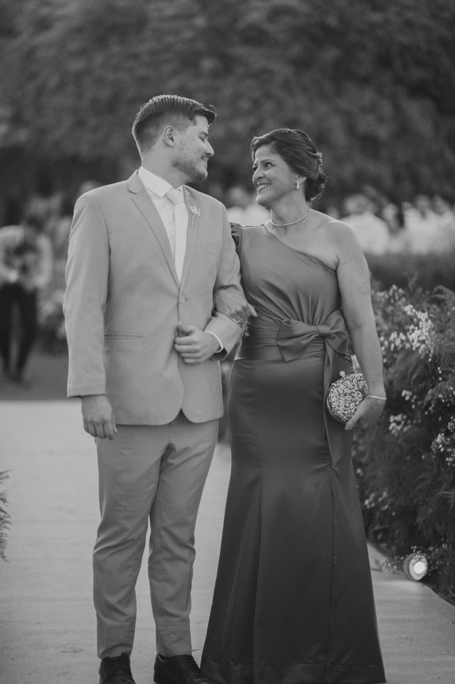 Black and white portrait of couple in formal wedding attire.