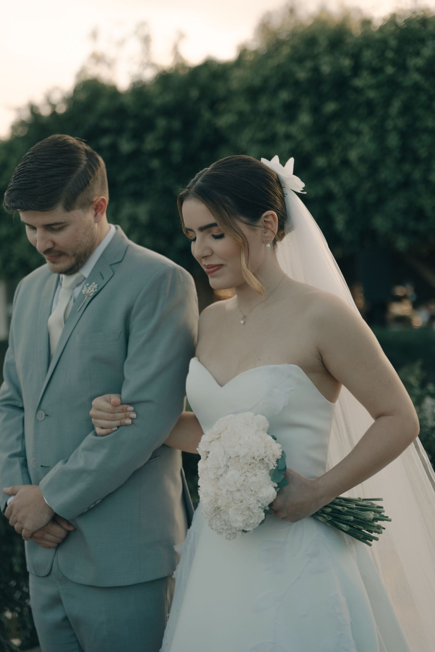 A couple shares an intimate moment during their outdoor wedding ceremony.