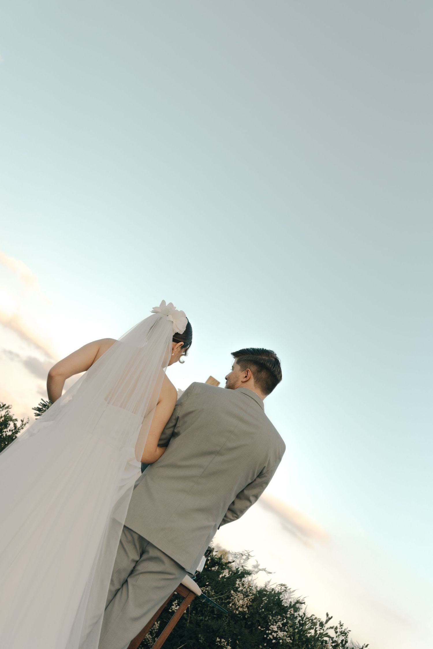Low angle view of a bride and groom during their outdoor wedding ceremony.