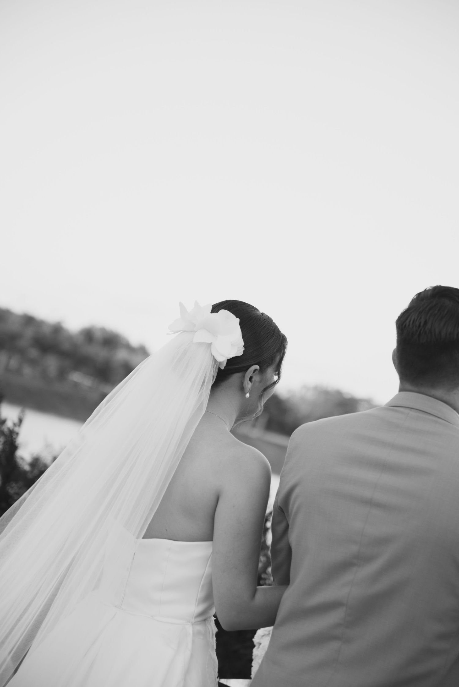 Back view of a bride and groom standing together during their wedding ceremony.