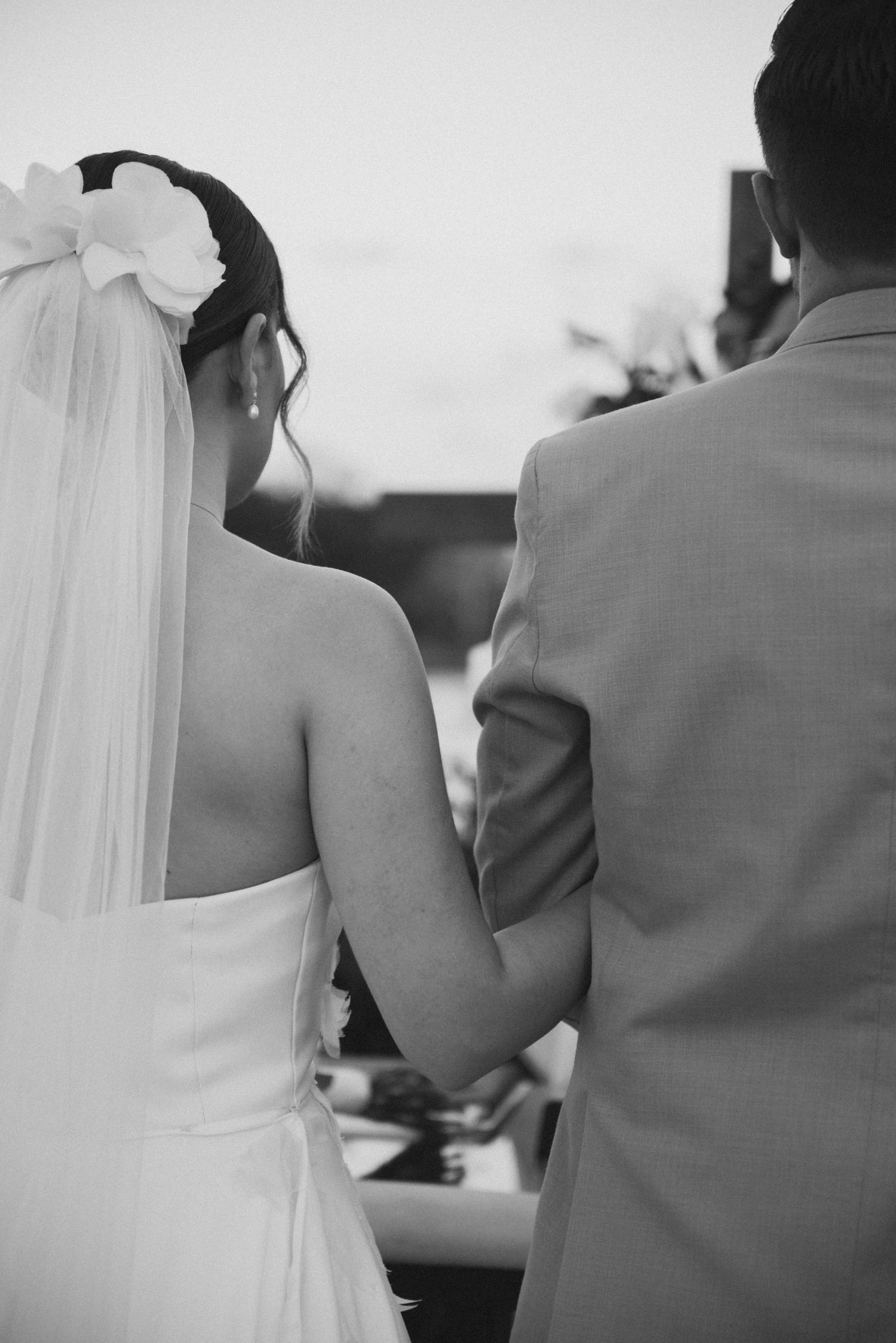 A bride and groom stand close together during their wedding ceremony.