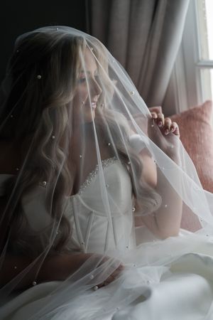A series of romantic bridal portraits showing a bride with a delicate veil in an indoor setting.