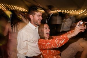 People dancing and celebrating at a lively party with energetic movements and expressions of joy.