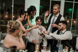 Guests enjoying a festive moment on the dance floor at an evening wedding reception.