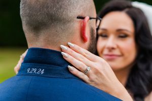 Intimate moment between newlyweds captured through soft, dreamy veil during outdoor portraits.