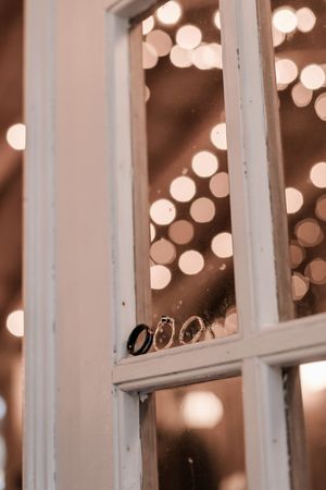White window frames against a blurred background of warm bokeh lights creating a romantic ambiance.