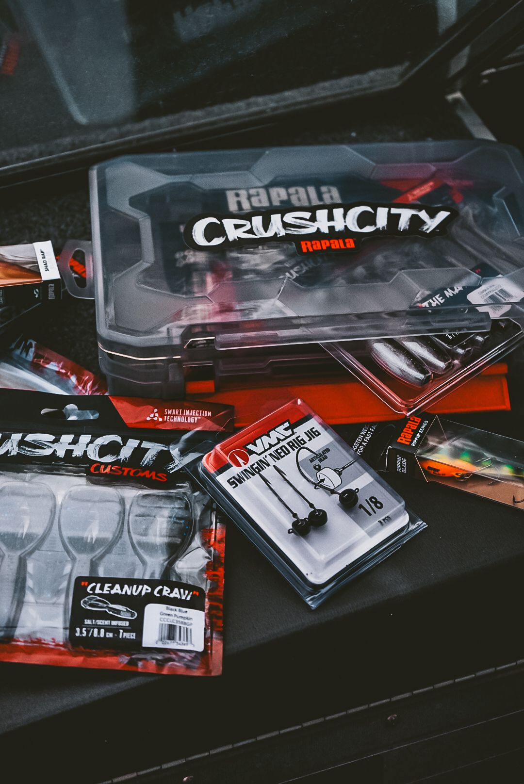 Collection of Crush City branded merchandise and products displayed on dark surface.