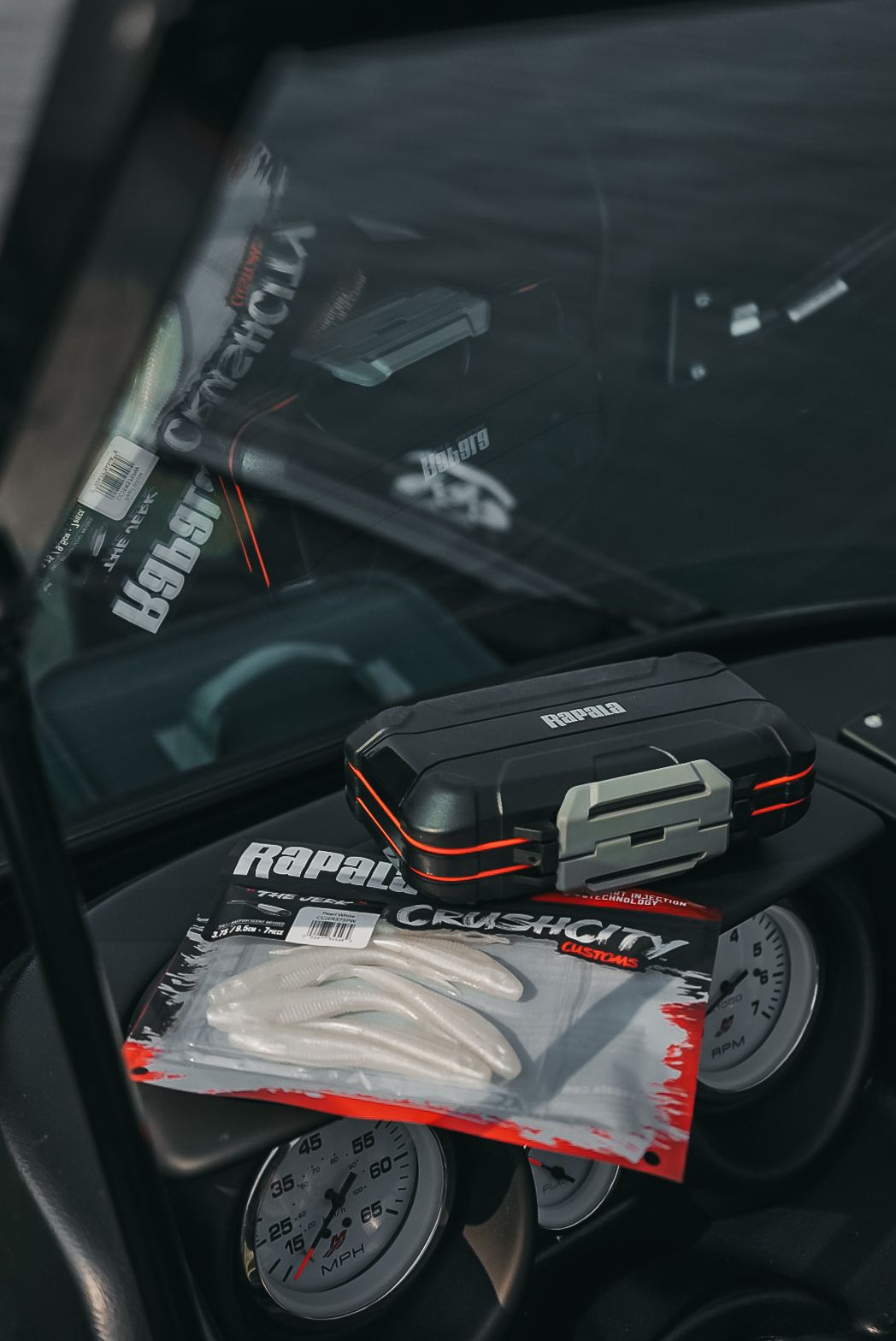 Rapala branded fishing gear and accessories arranged on a dark surface.