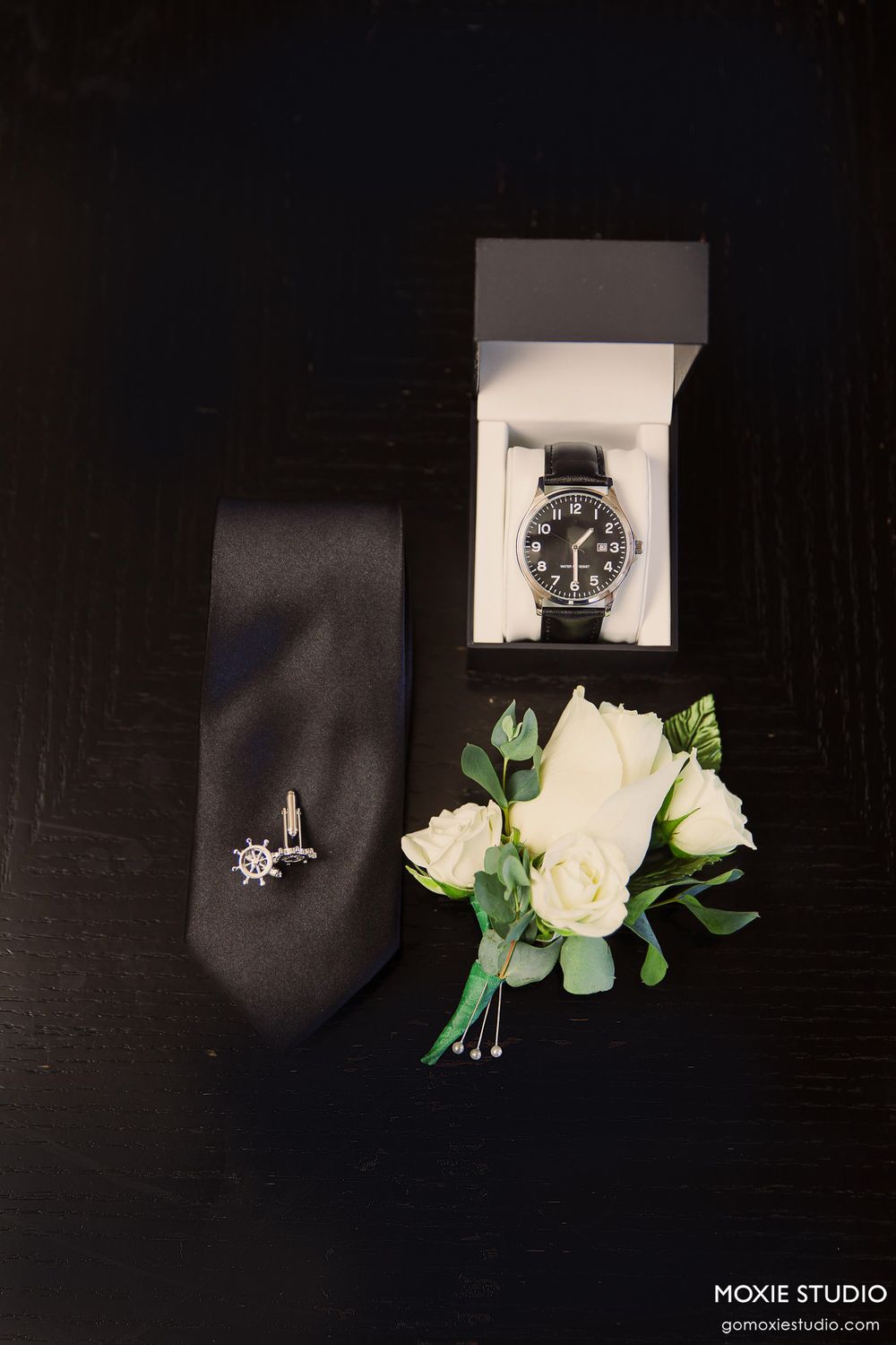 A series of black and white product photos showing watches and floral arrangements against dark backgrounds.