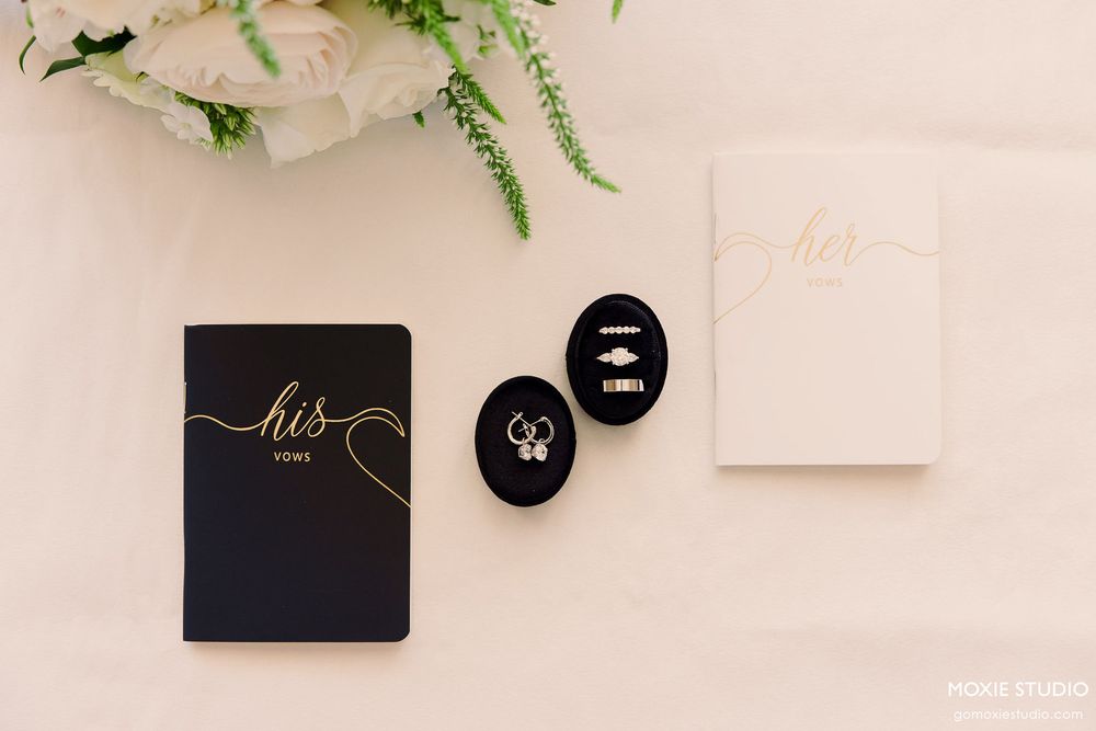 Elegant wedding invitation suite in black and white with gold foil accents and delicate greenery details.