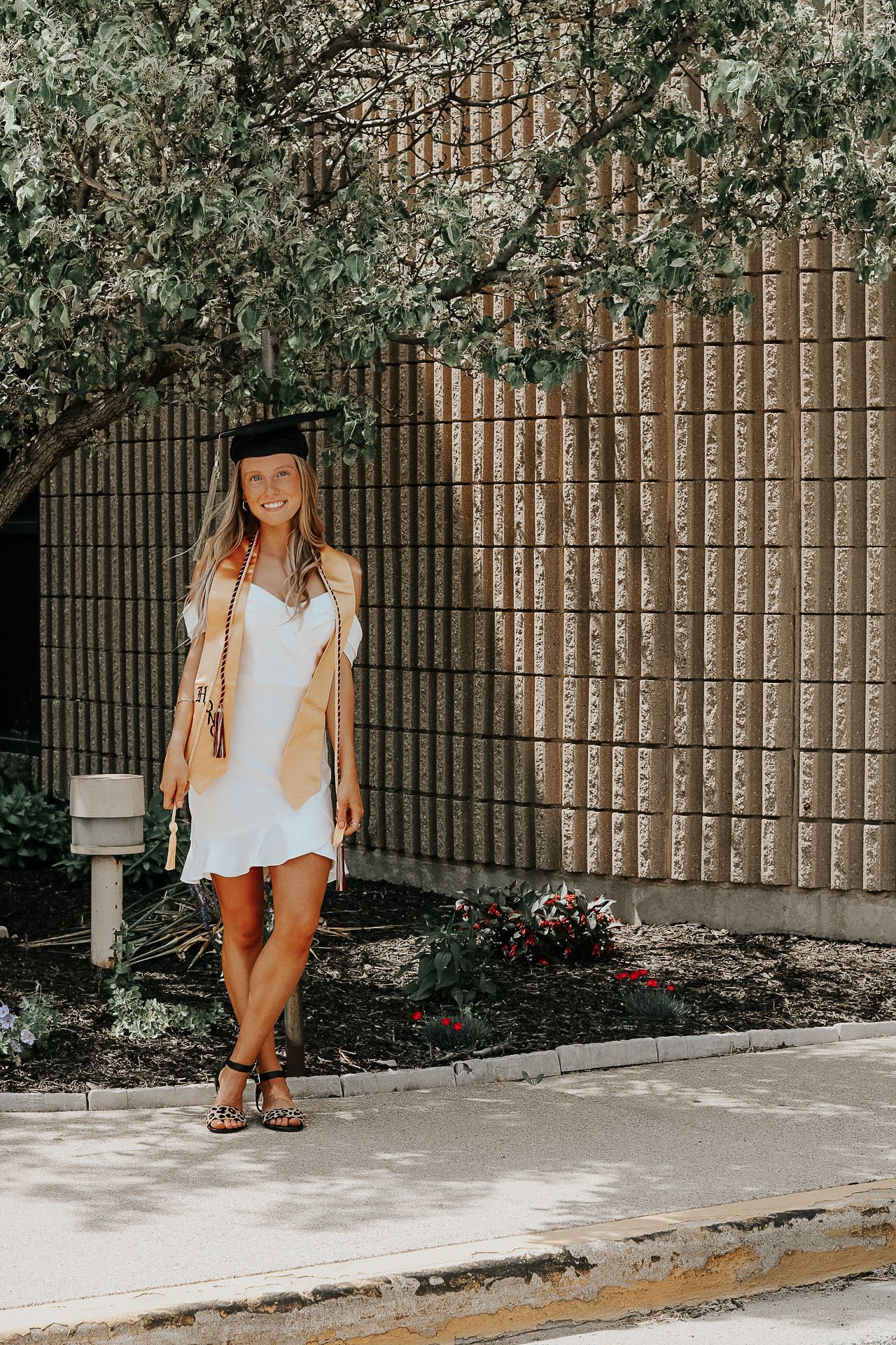 A series of casual fashion lifestyle photos taken against a brick wall and garden background.