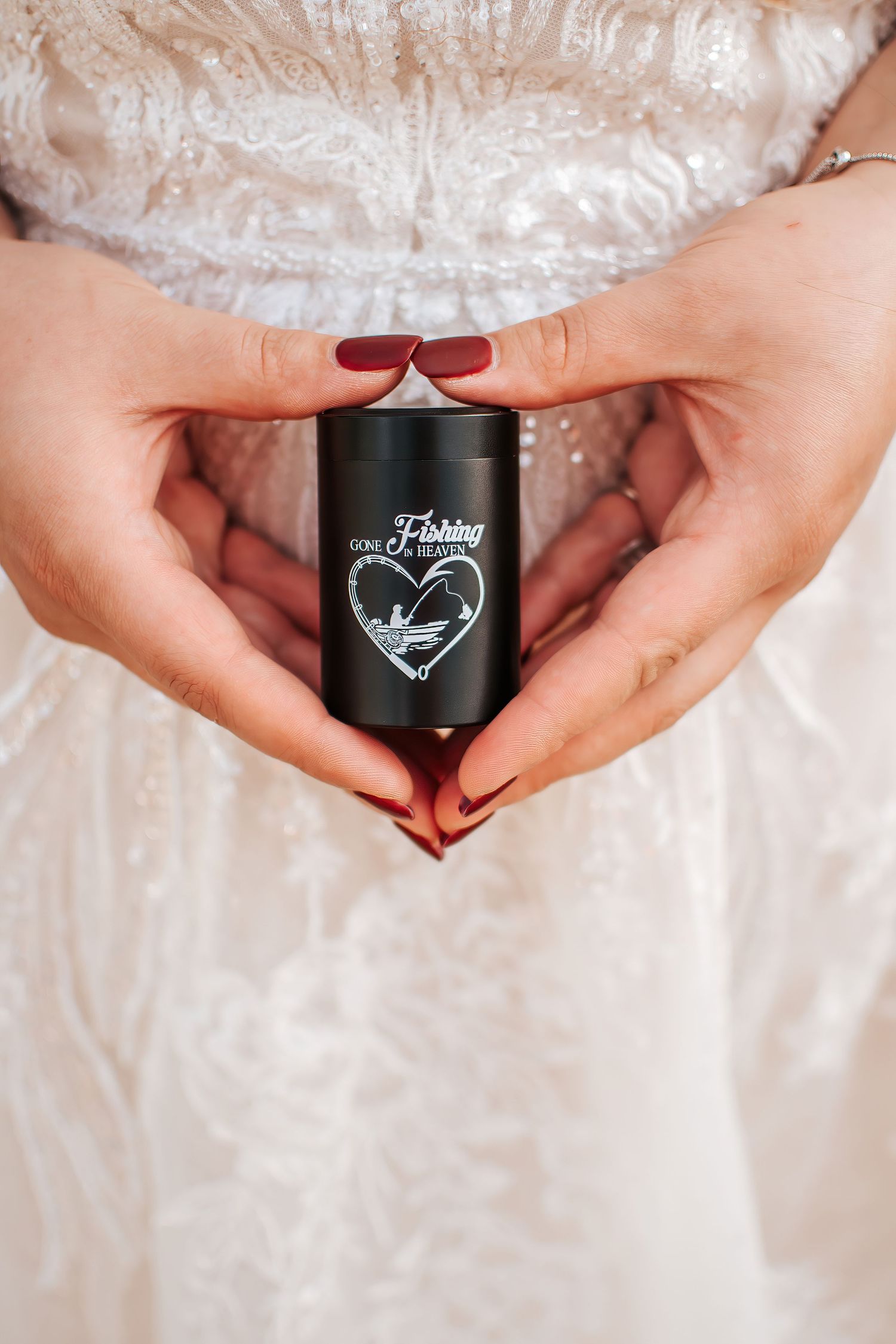 Close-up of hands holding a small earn with a heart design while wearing a wedding dress. A girl and her gradnfather in  Ukiah, Oregon.