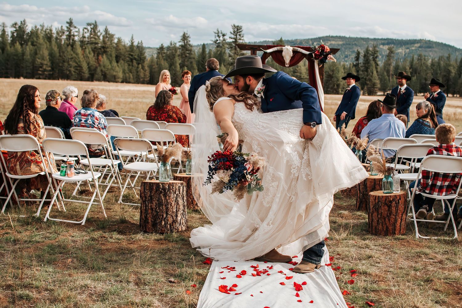Wedding couple performing a romantic dip exiting their ceremony in Oregon.
