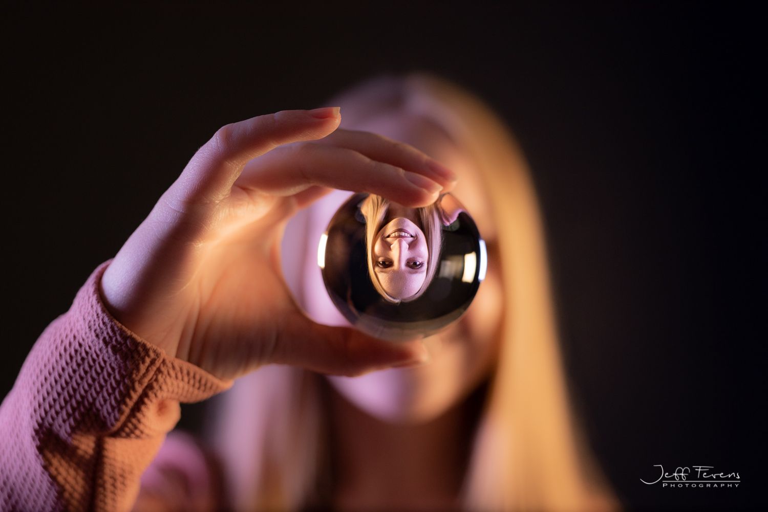 Portrait of woman with long blond hair in crystal ball.