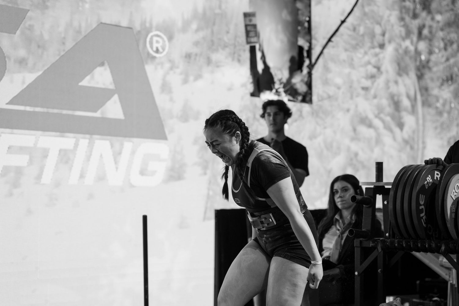 Black and white image of a powerlifting competition venue setup.