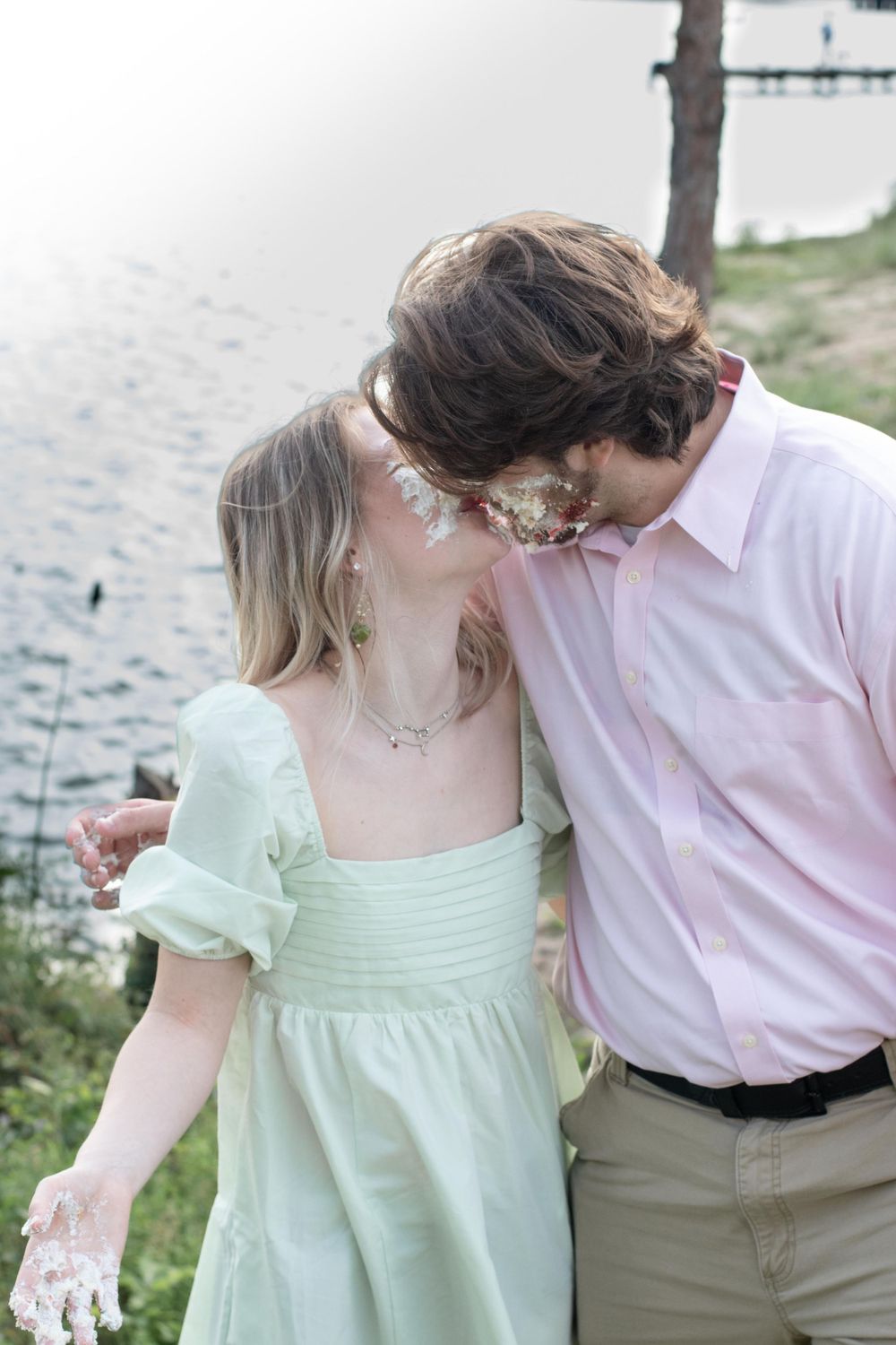 Intimate waterfront moment in pastel pink and mint green outfits.