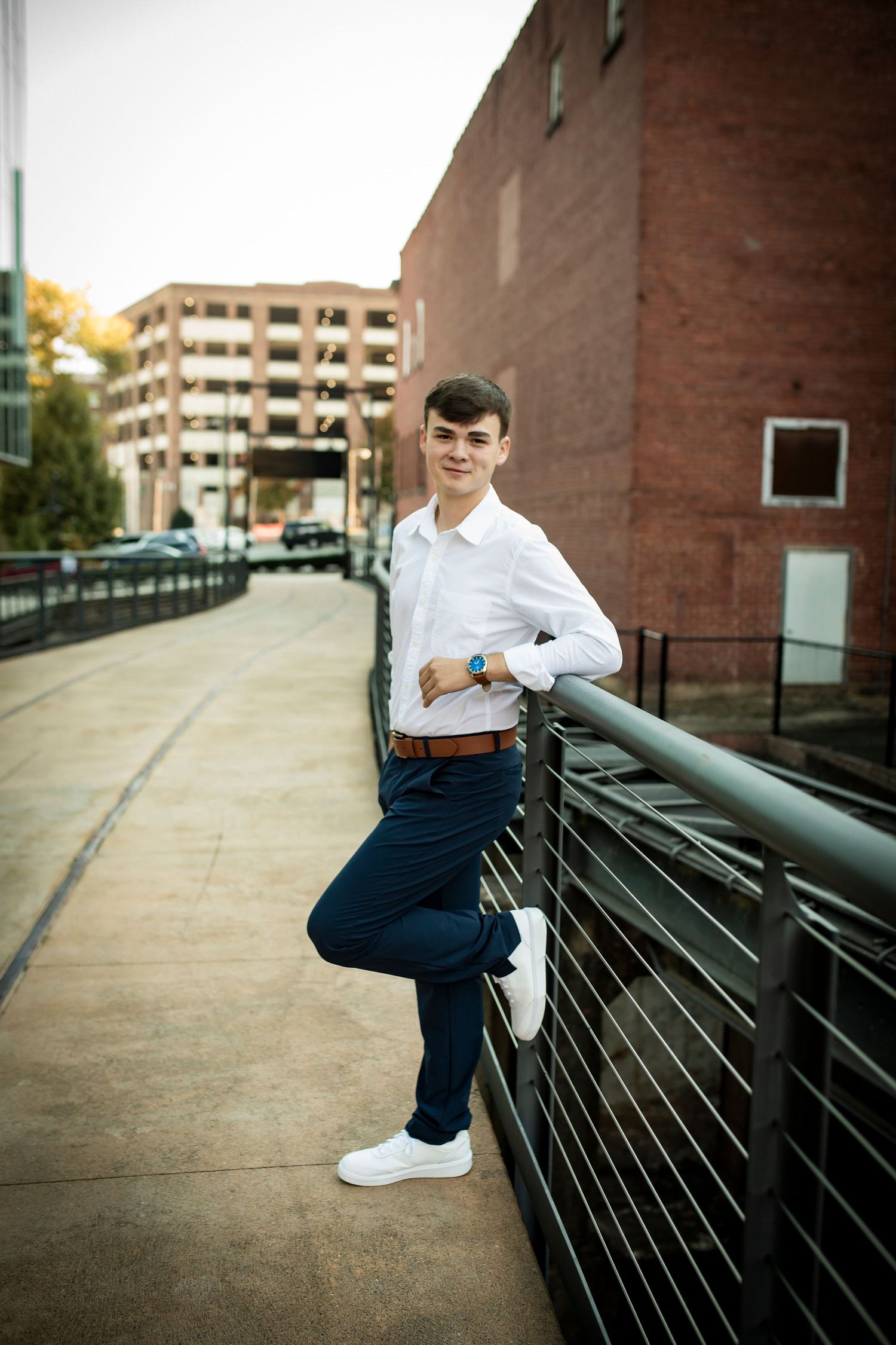 A series of photos showing someone sitting on a metal railing against a brick building exterior in casual attire.