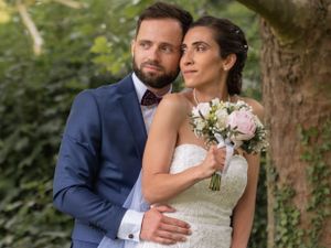 Romantic outdoor wedding photos under trees with navy suit and white dress details.