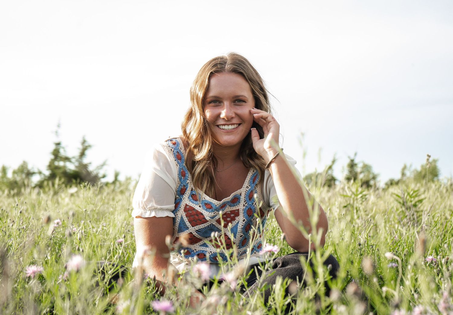 A senior portrait sitting in a flower field