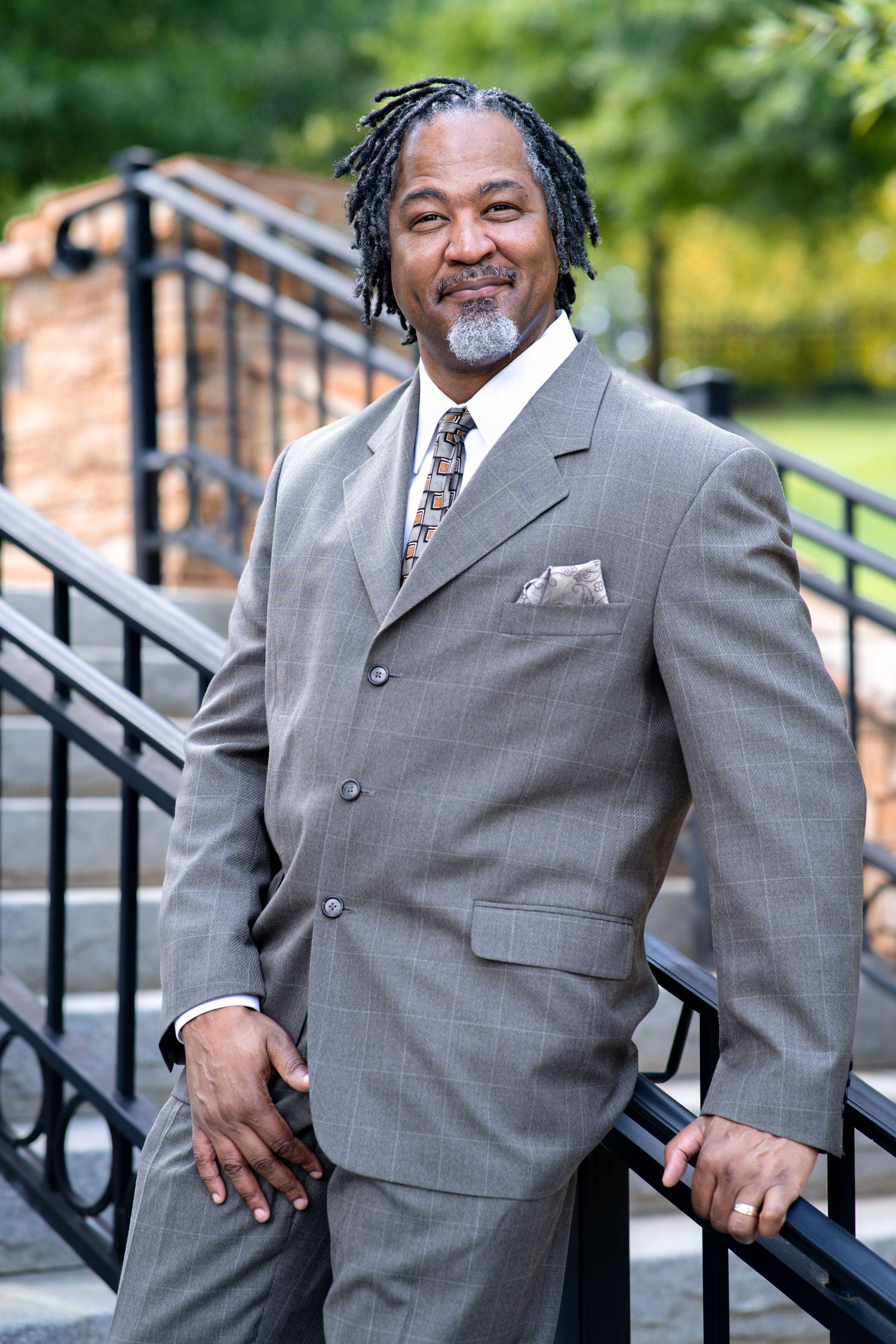 man posing on steps, wearing gray suit, marietta, Georgia