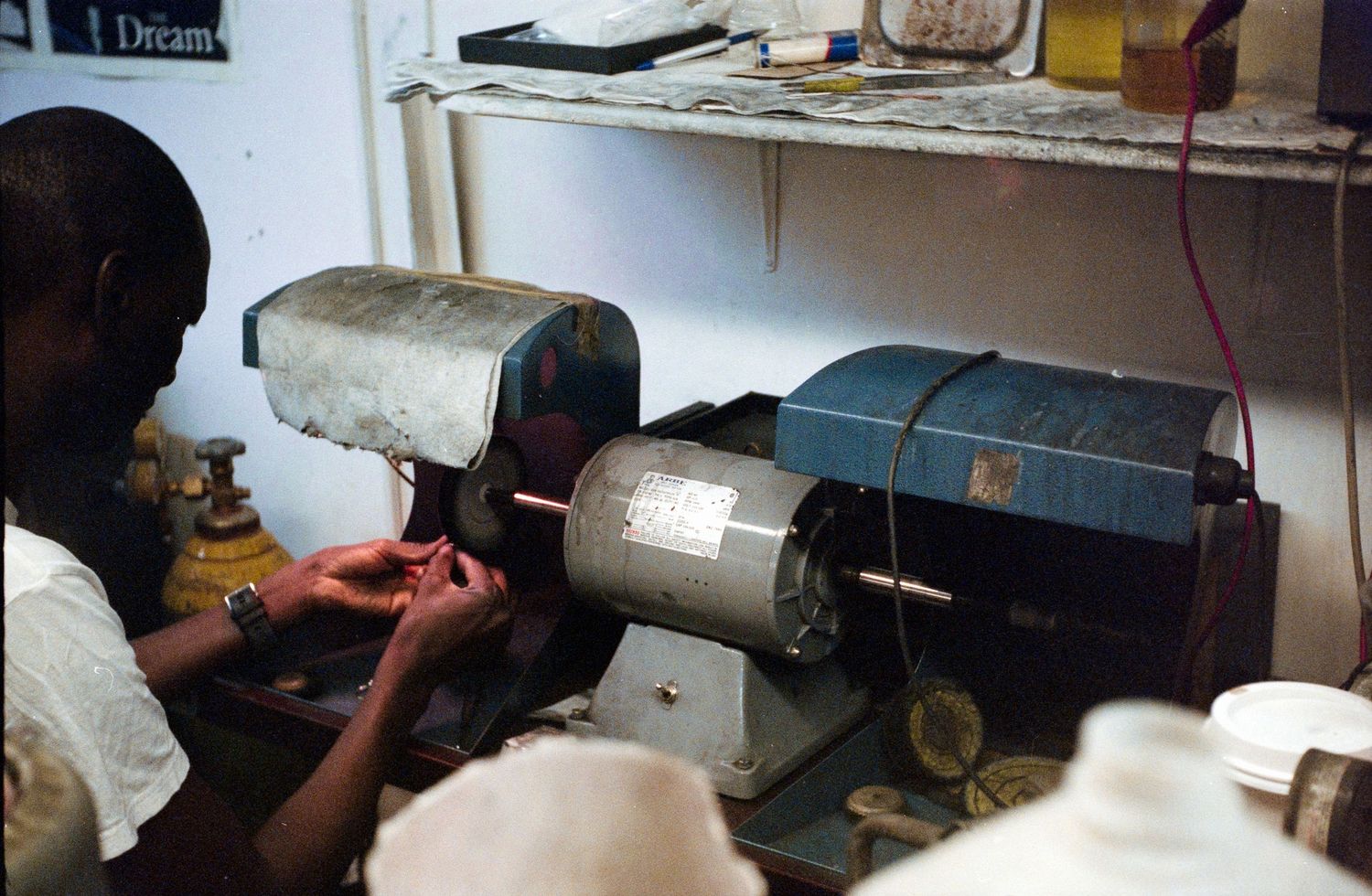 Workshop scene with industrial grinding wheels and machinery on workbench.
