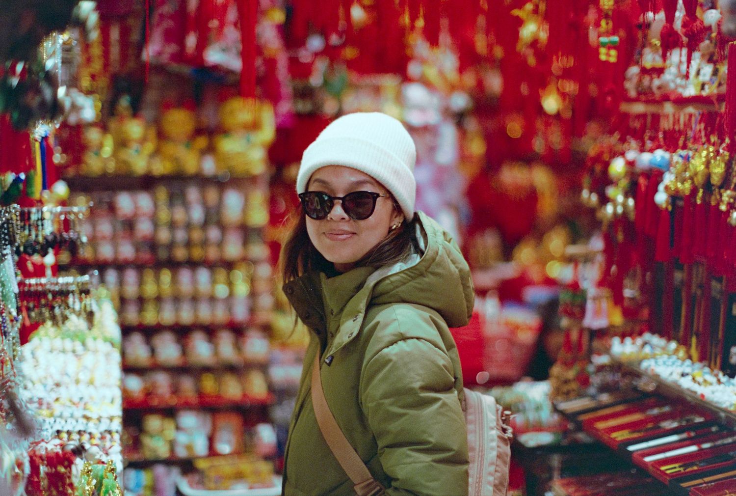 Shopping scene at festive market with red lanterns and decorations.