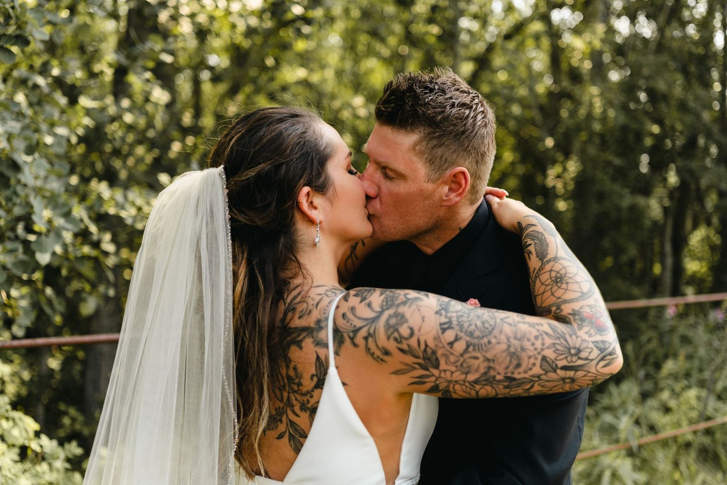Bride and Groom sharing a kiss on their wedding day at Demmit Hall outside of Grande Prairie Alberta