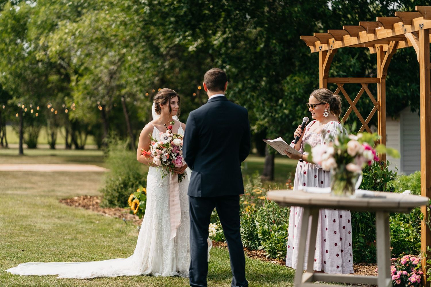 Intimate wedding outside of Grande Prairie, Alberta on the brides land. The bride and groom share a smile during the vow