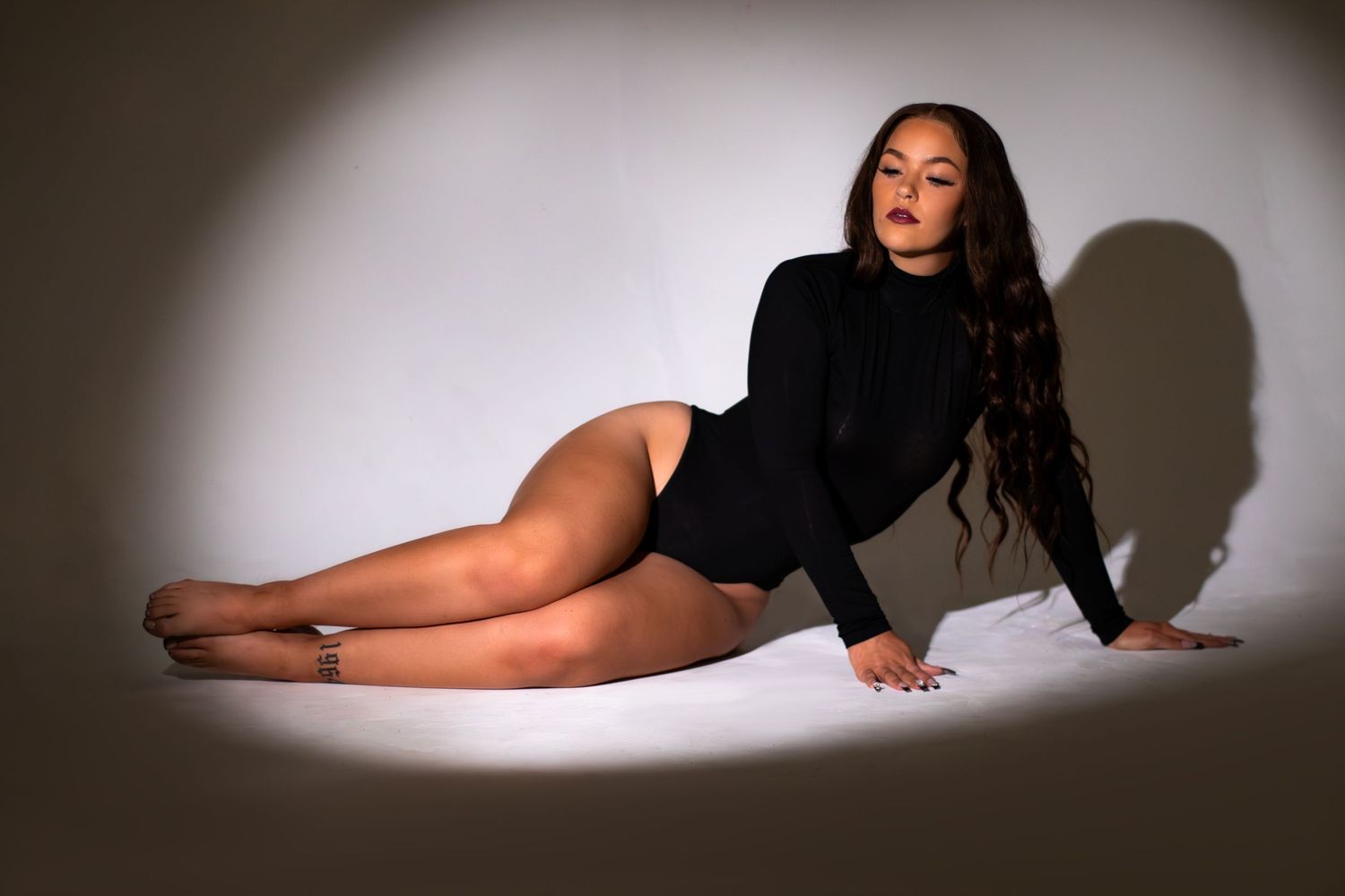 Model posing in a Birmingham studio under a spotlight.