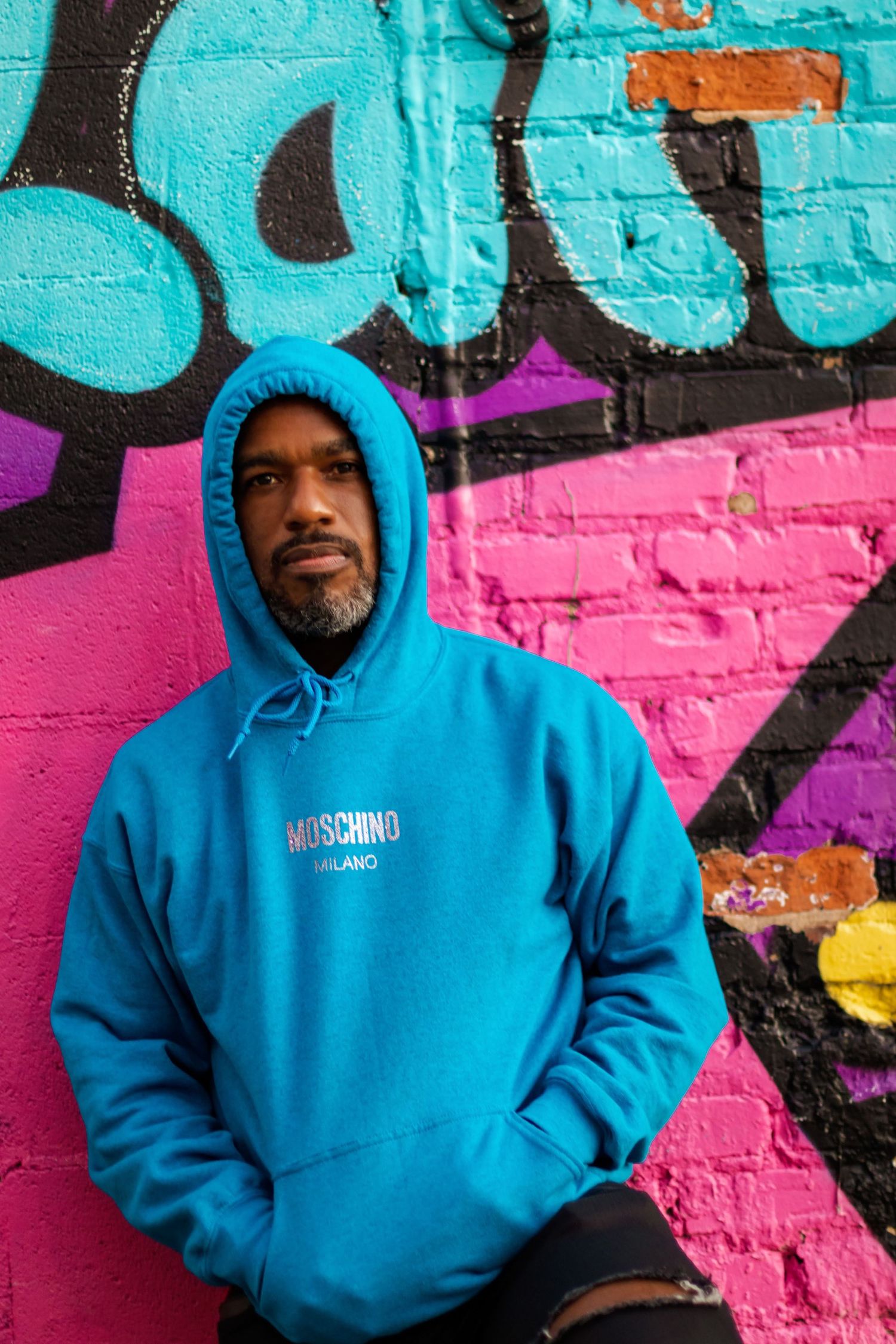 Colorful portrait of a man standing next to graffiti in Atlanta, GA.