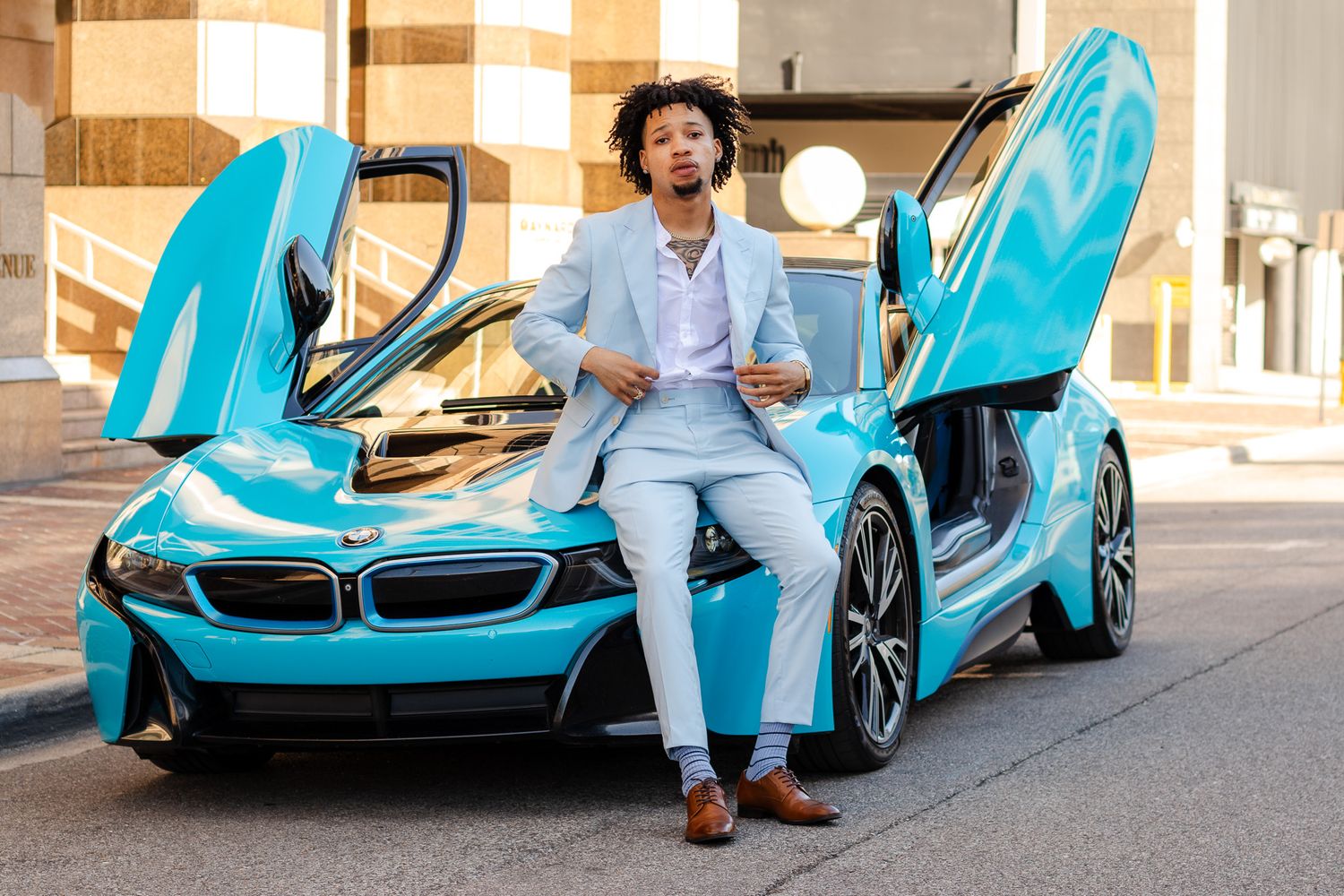 Model taking photos next to his BMW i8 downtown Birmingham, AL.