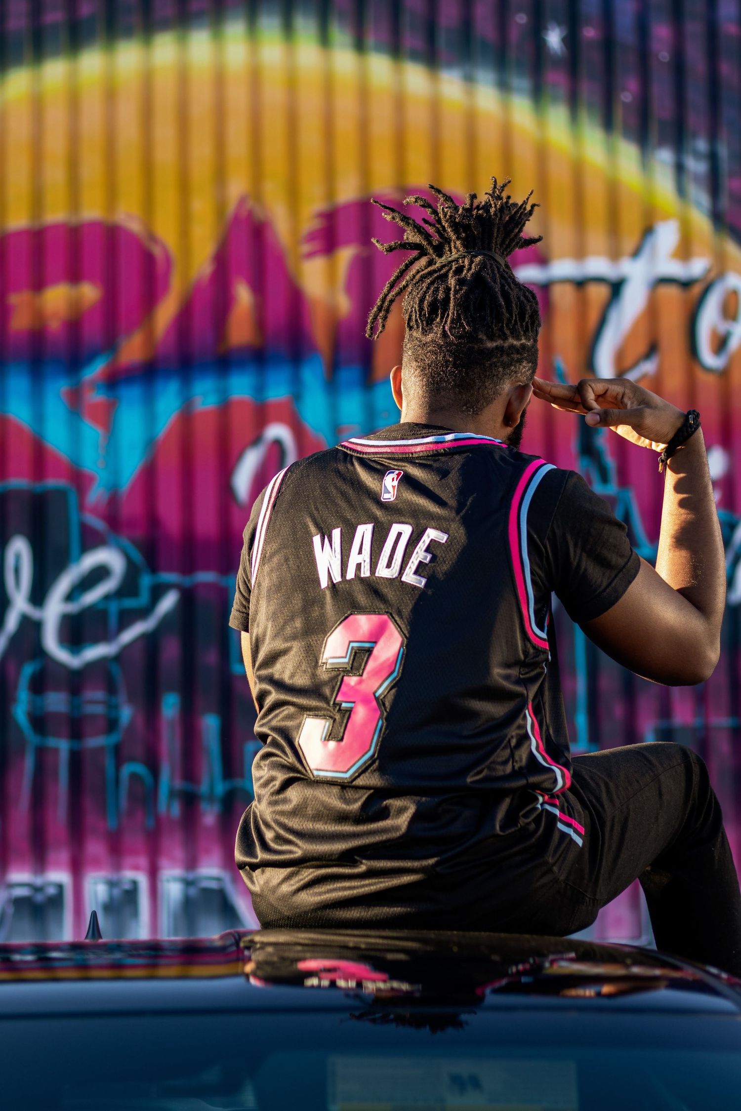 Basketball jersey against colorful graffiti wall shows urban street style.