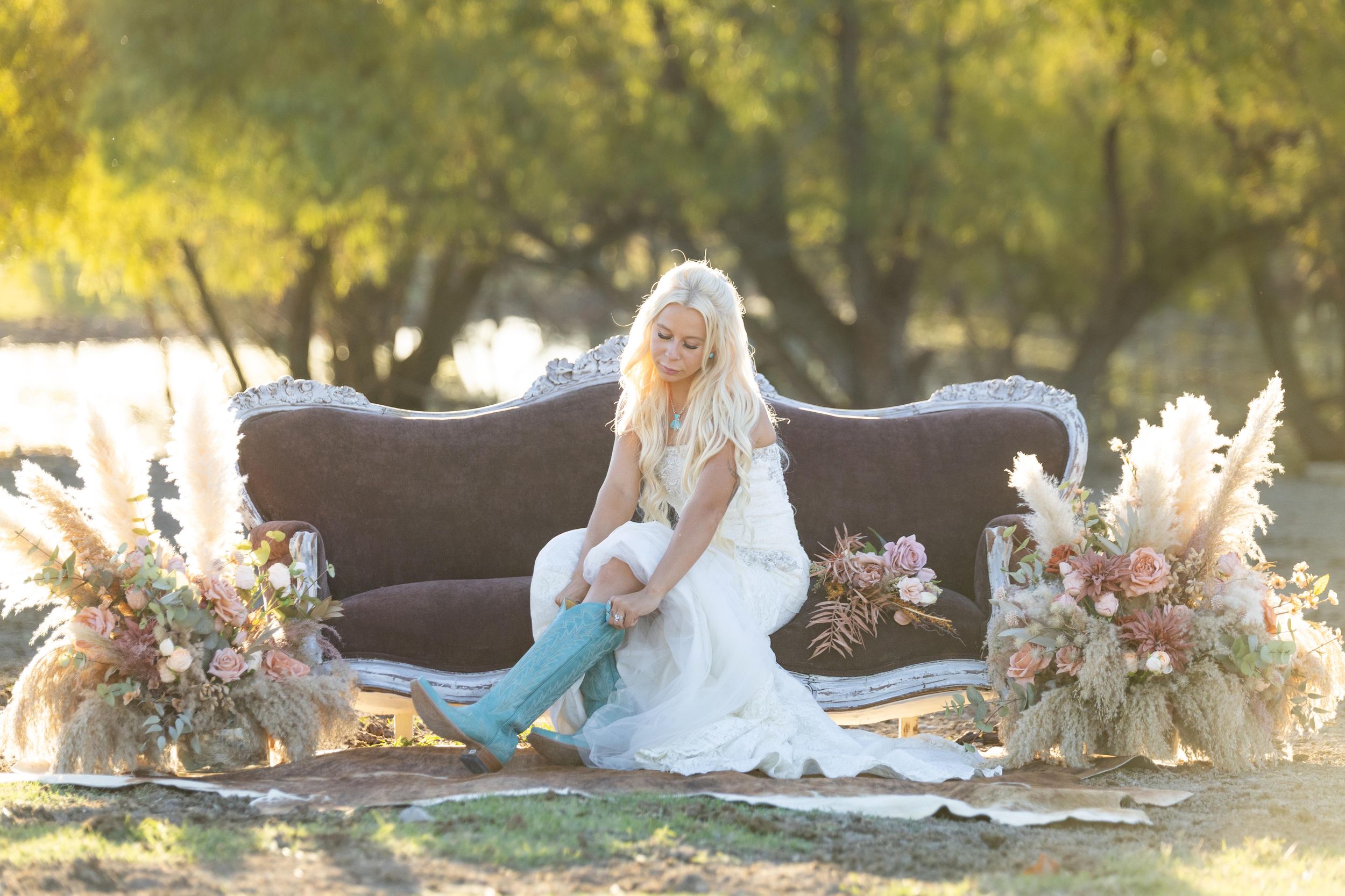 western bridal portrait session, turquoise cowgirl boots, antique couch in a pasture at sunset.