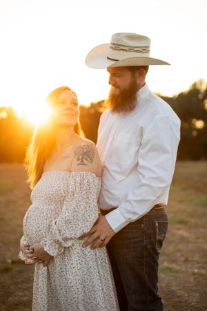 maternity photography pregnant woman looking over her shoulder at her partner