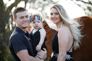 young couple with dad holding baby girl