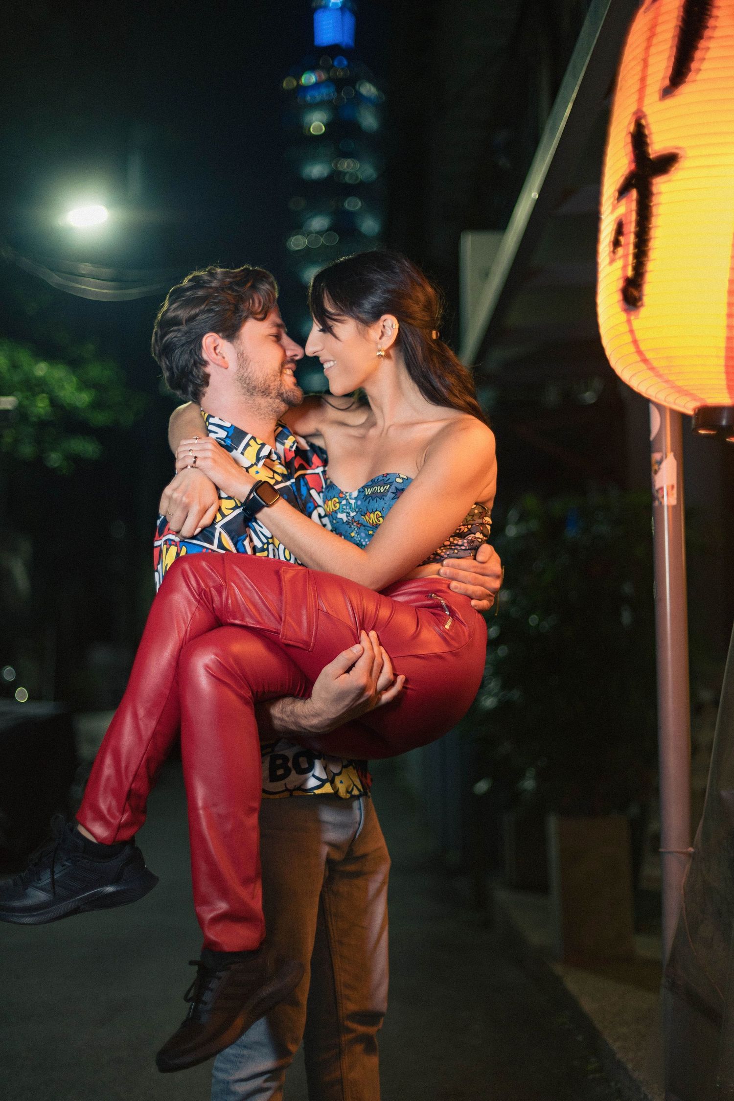 A couple from Germany embracing at Takemura Izakaya, with Taipei 101 as their backdrop.