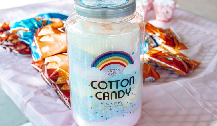 Cotton candy mason jar drink with rainbow design on colorful table setting.