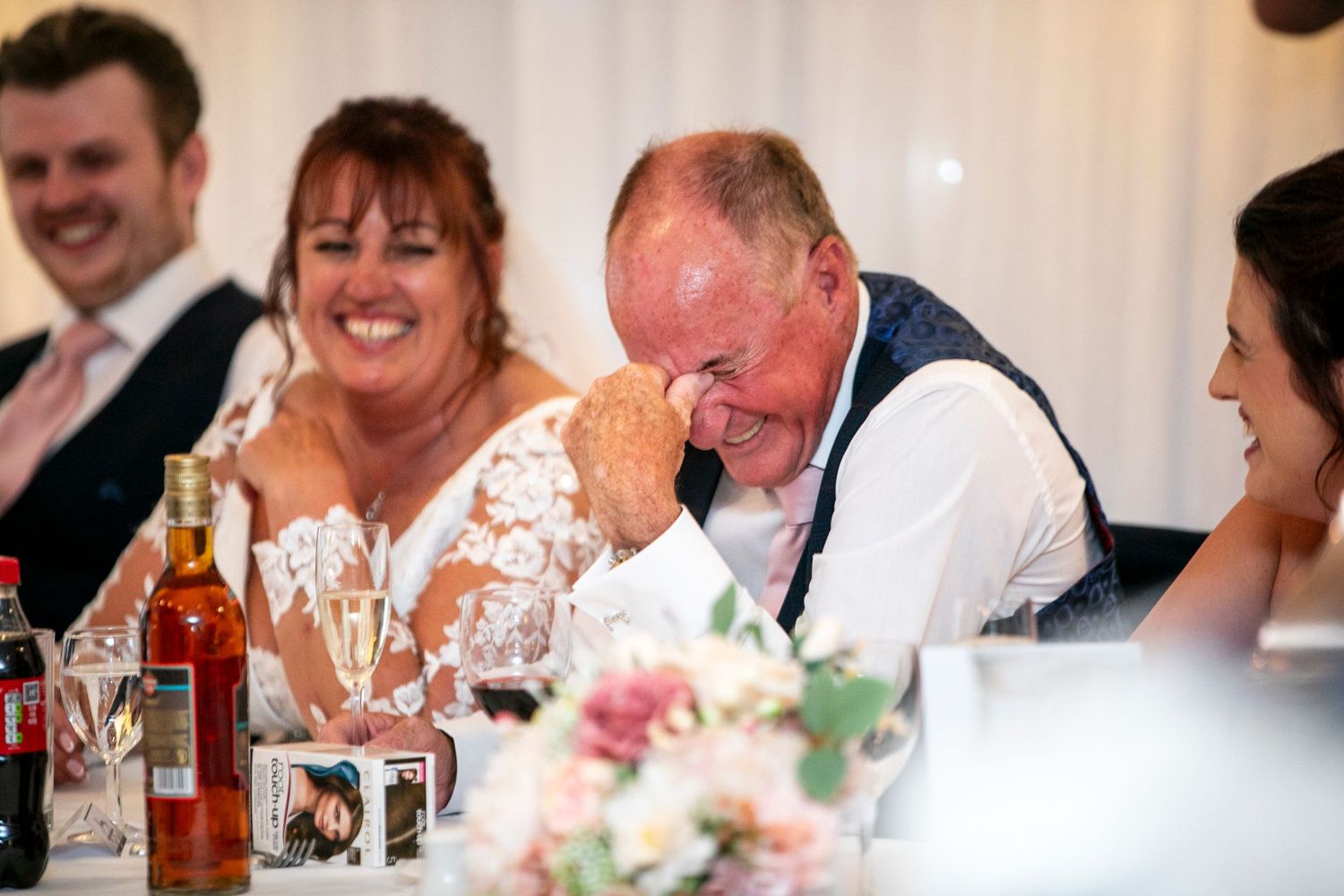 Wedding reception guests sharing joyful moments during dinner celebrations.
