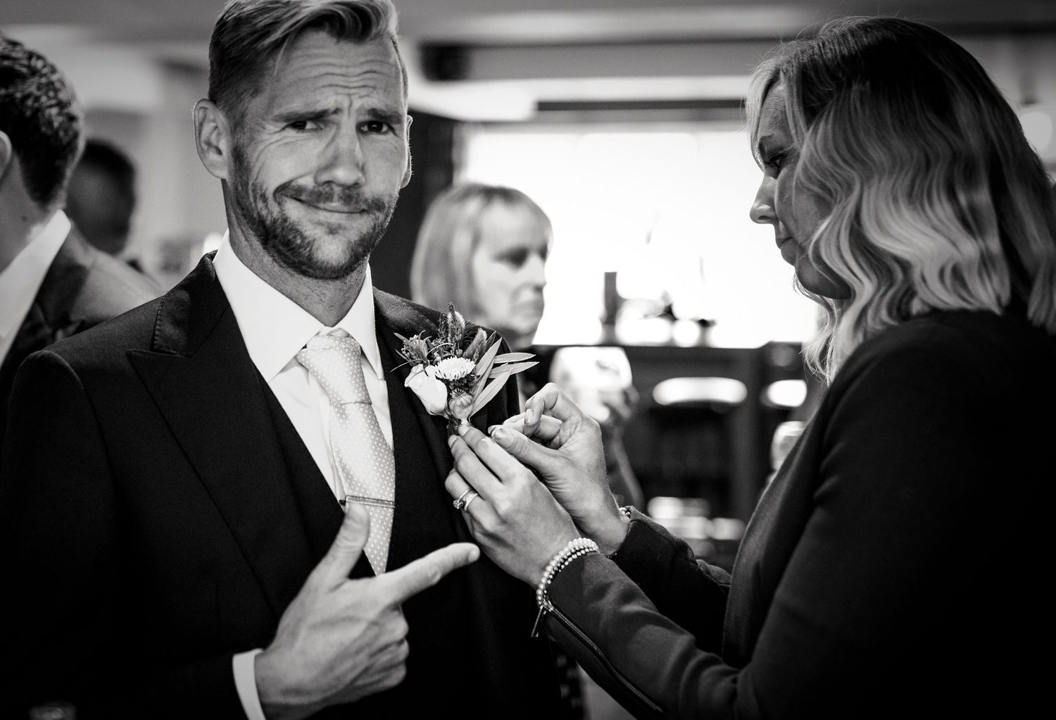 Black and white candid shots of guests enjoying drinks at reception.