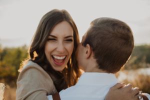 Joyful romantic moment captured during sunset with natural lighting.