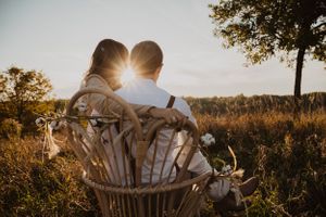 Sun flare illuminates a romantic outdoor scene with natural landscape.
