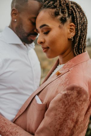 Intimate close-up portrait of a couple in formal attire showing tender emotion.