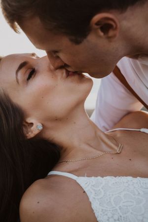 Intimate close-up portrait with delicate jewelry details in natural light.
