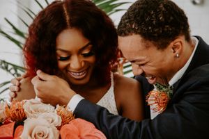 Joyful wedding moment captured with tropical flowers and natural expressions.