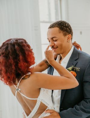 Dancing couple shares playful moment during wedding celebration.