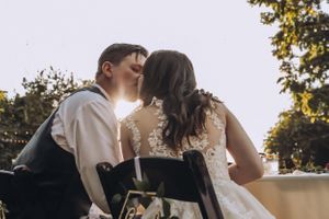 An intimate moment between newlyweds captured in warm sunlight.