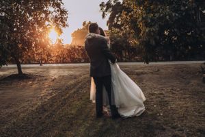 Panoramic wedding photos at sunset with trees creating a natural backdrop.