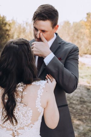 Emotional wedding couple sharing intimate moment during sunset portrait session.