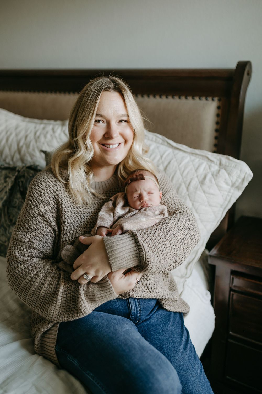 A cozy lifestyle portrait on a bed with soft natural window light.