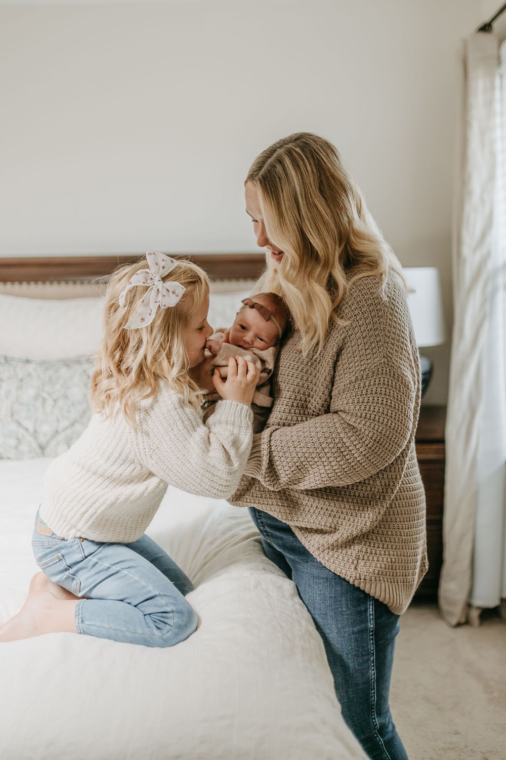 A heartwarming moment shared between family members on a cozy bed.